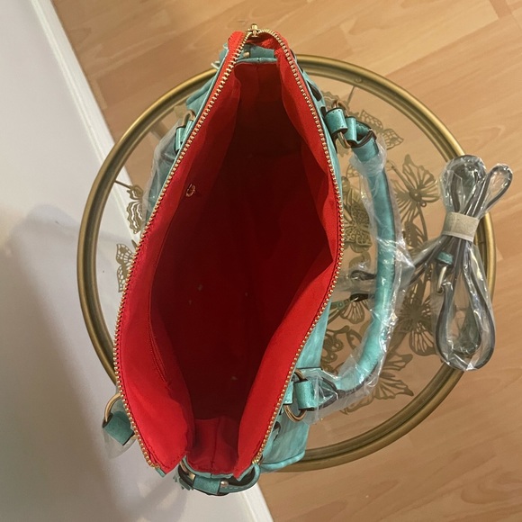 Turquoise large faux leather handbag with tassel accents. - Picture 4 of 4